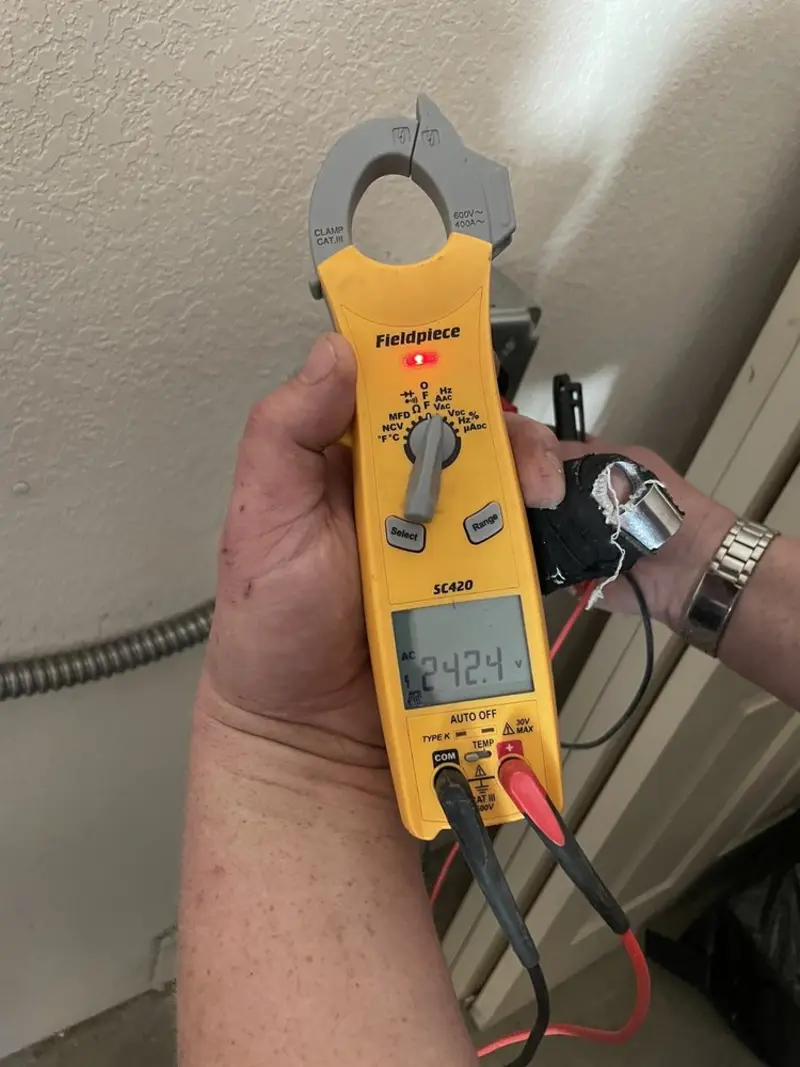 Voltage testing with clamp meter during Outlet Installation in Davis